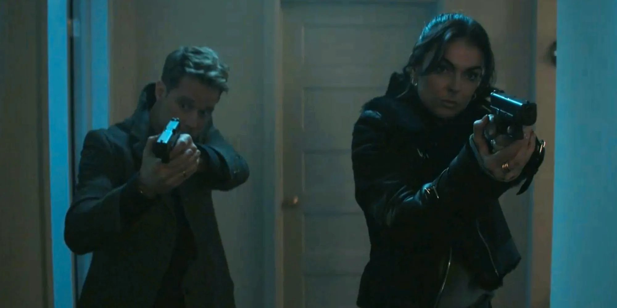 Serinda Swan as Karla Dixon aiming her weapon in Reacher and Shaun Sipos' David O'Donnell doing the same thing Image