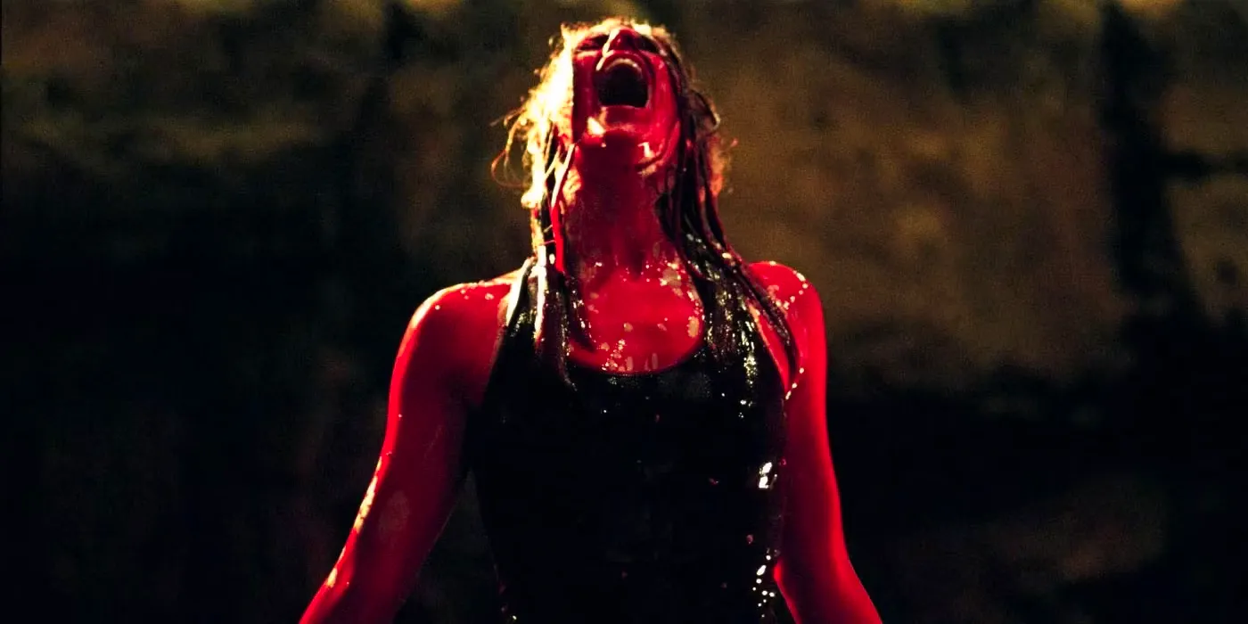 Shauna Macdonald as Sarah covered in blood and screaming in the cave in The Descent. Image