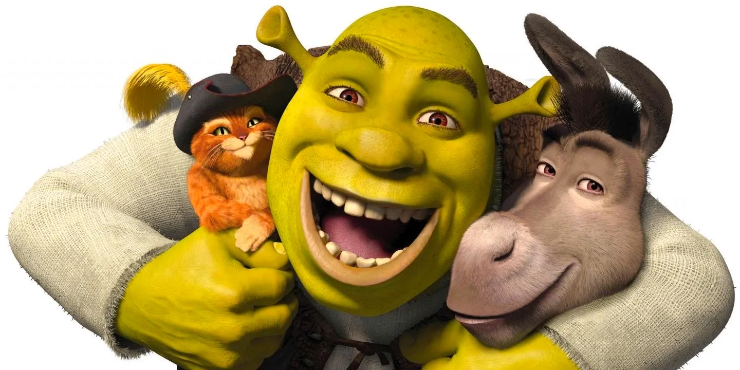 Shrek hugging Donkey and Puss in Boots against a white background in a promo image for Shrek Image