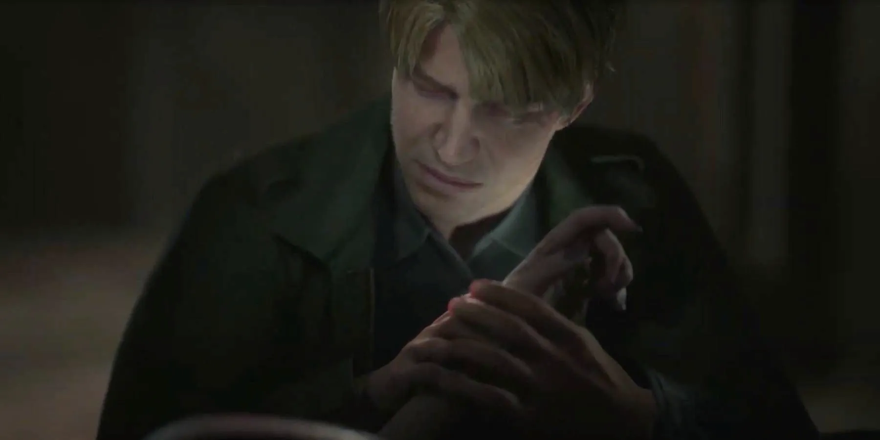 Silent Hill 2 Remake James holding Maria's hand after finding her dead in Room 208. Image