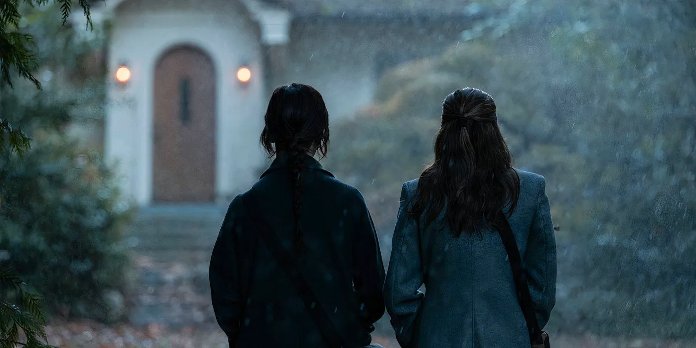 Sisters Barnes and Paxton walk in the rain in Heretic-1 Image