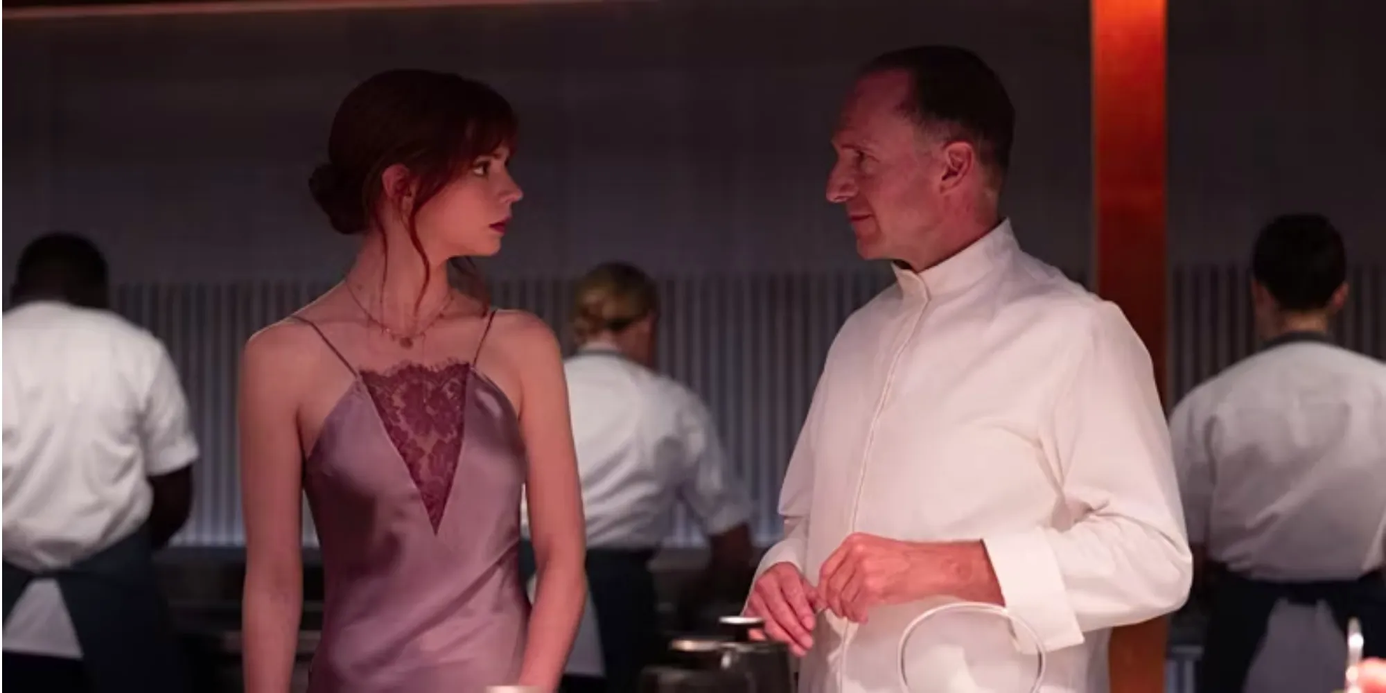 Slowik (Ralph Fiennes) and Margot (Anya Taylor-Joy) talking in the kitchen in The Menu Image