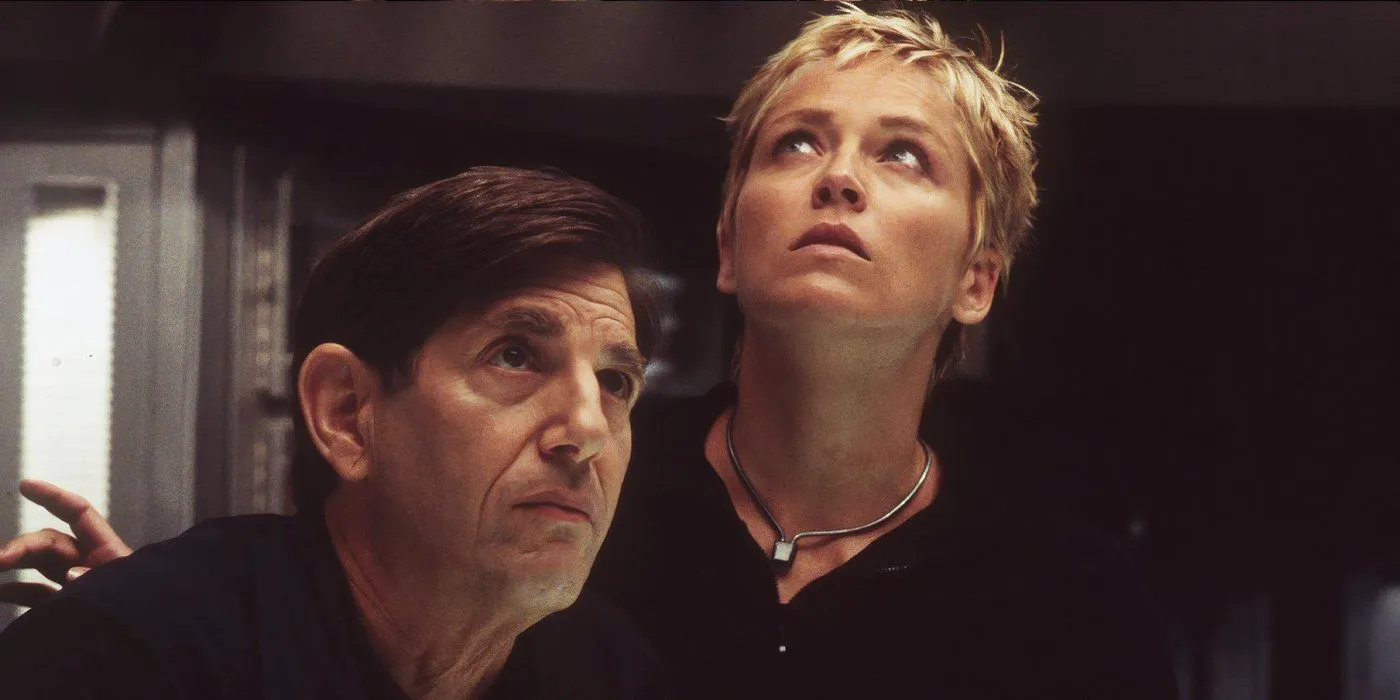 Sphere (1998) Sharon Stone and co-star are looking worried with a dark, black backdrop  Image