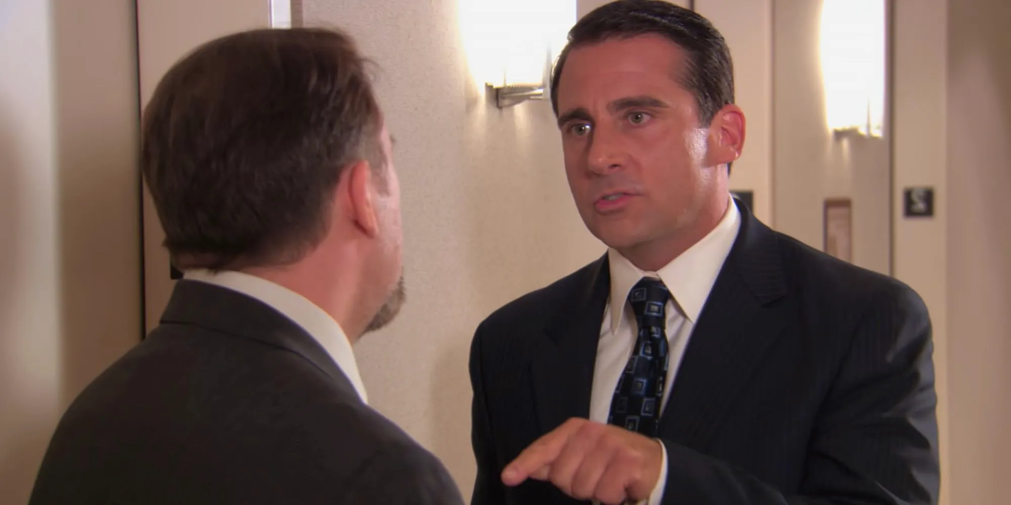 Steve Carell as Michael Scott talking to Ricky Gervais as David Brent in The Office Image