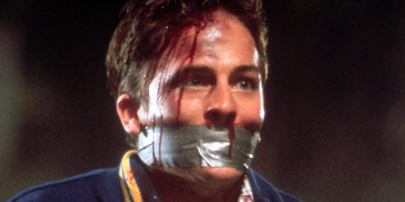 Steven Orth looking sideways with tape on his mouth in Scream Image