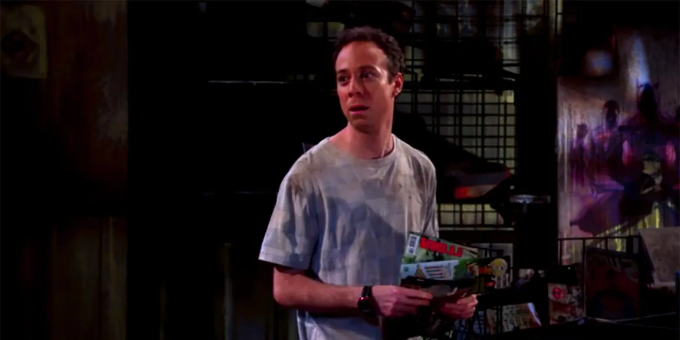 Stuart standing in the middle of his burned down comic book store in The Big Bang Theory. Image