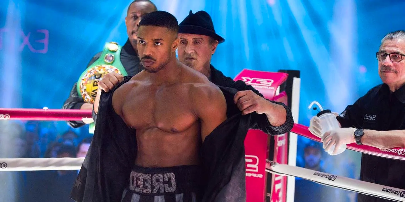 Sylvester Stallone as Rocky Balboa taking off Michael B Jordan's robe in Creed 2 Image