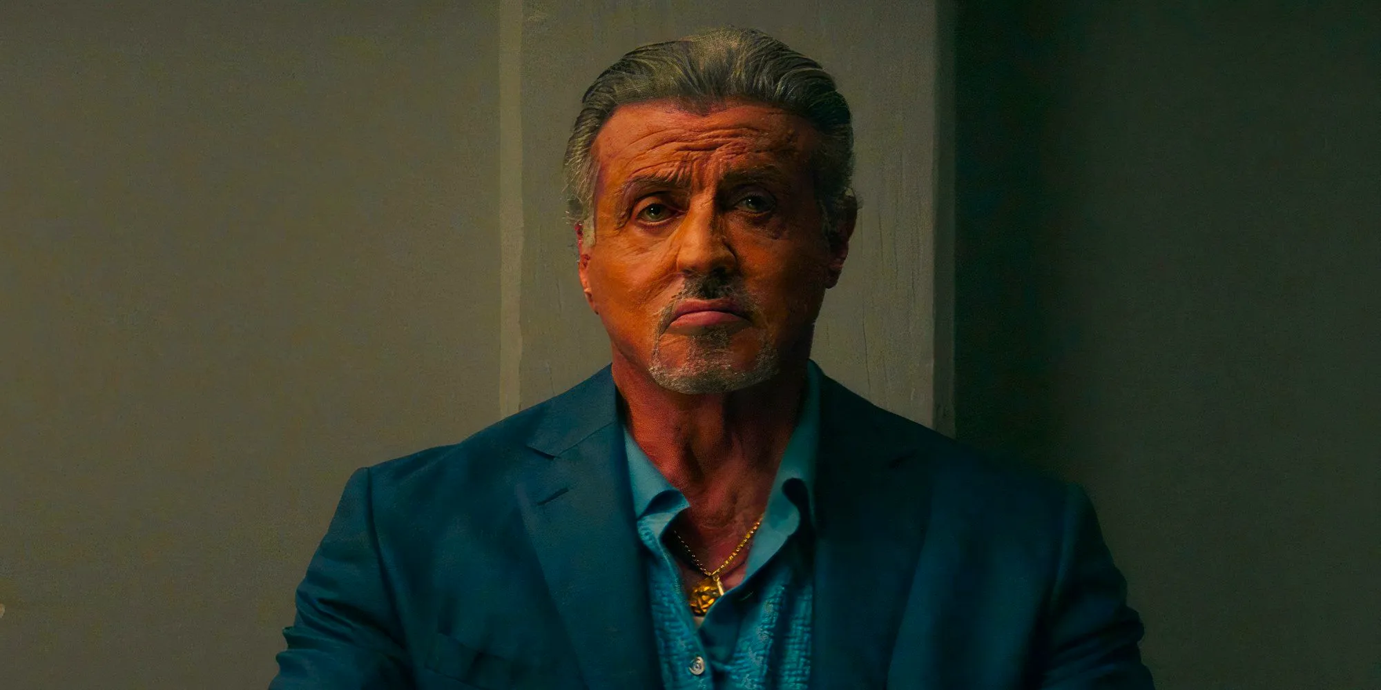 Sylvester Stallone looks contemplative in a scene from Tulsa King season 1 Image