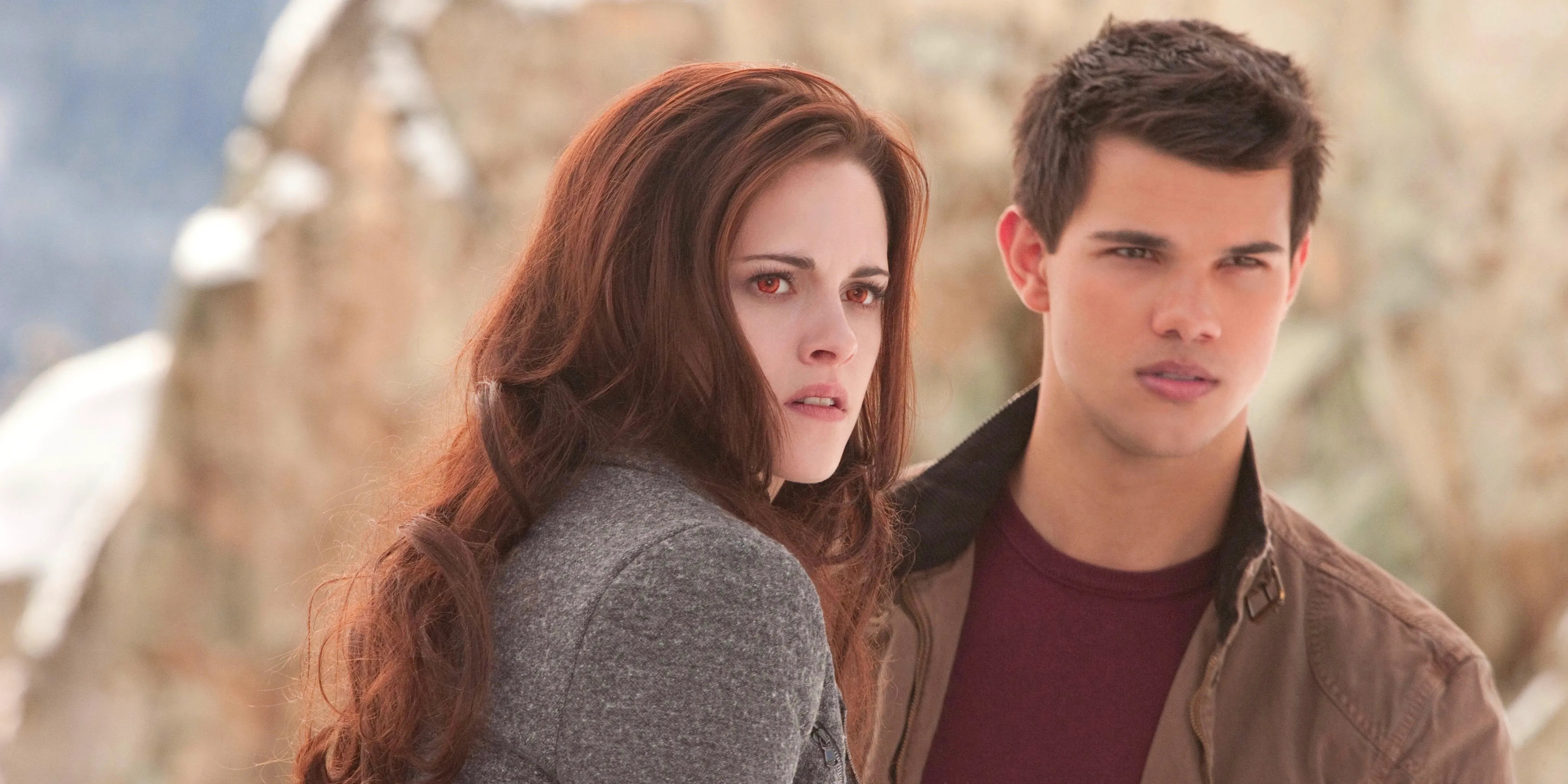 Taylor Lautner as Jacob and Kristen Stewart as Bella as they look off in the distance while outside in The Twilight Saga Breaking Dawn Part 2 Image