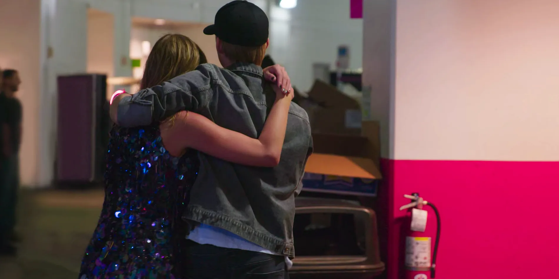 Taylor Swift and Joe Alwyn in an embrace facing away from the camera in Miss Americana Image