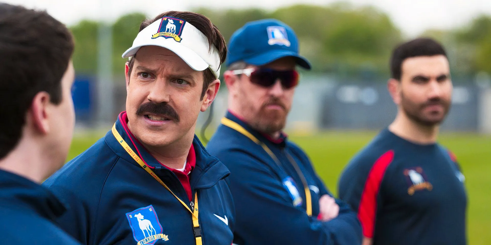 The coaching team in Ted Lasso season 3, having a conversation Image