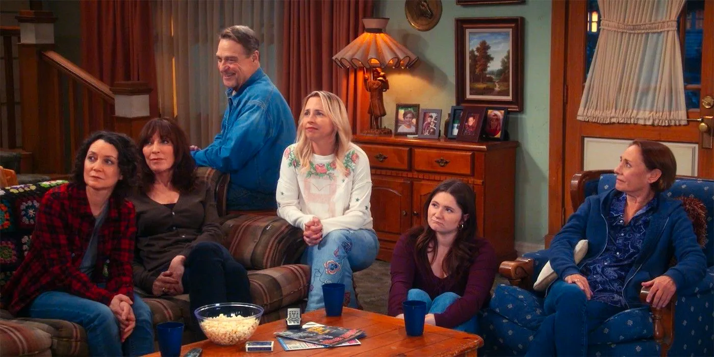 The Conners family sitting around the couch in a cabin in the sitcom Image