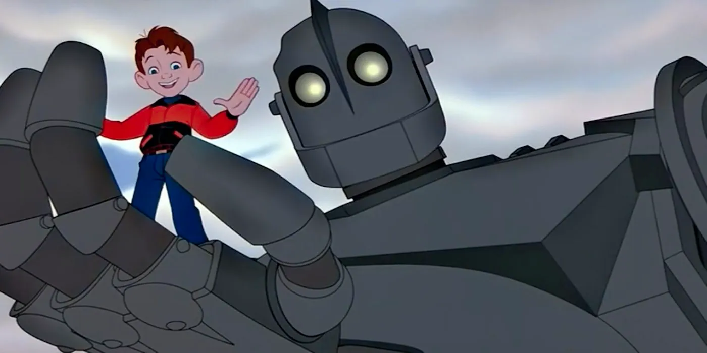 The Iron Giant with Hogarth being held by the robot Image