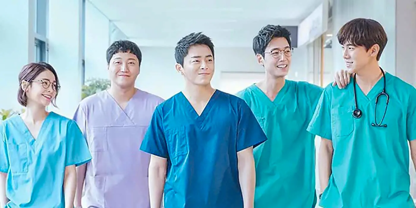 The main cast members from Hospital Playlist in scrubs walking together. Image