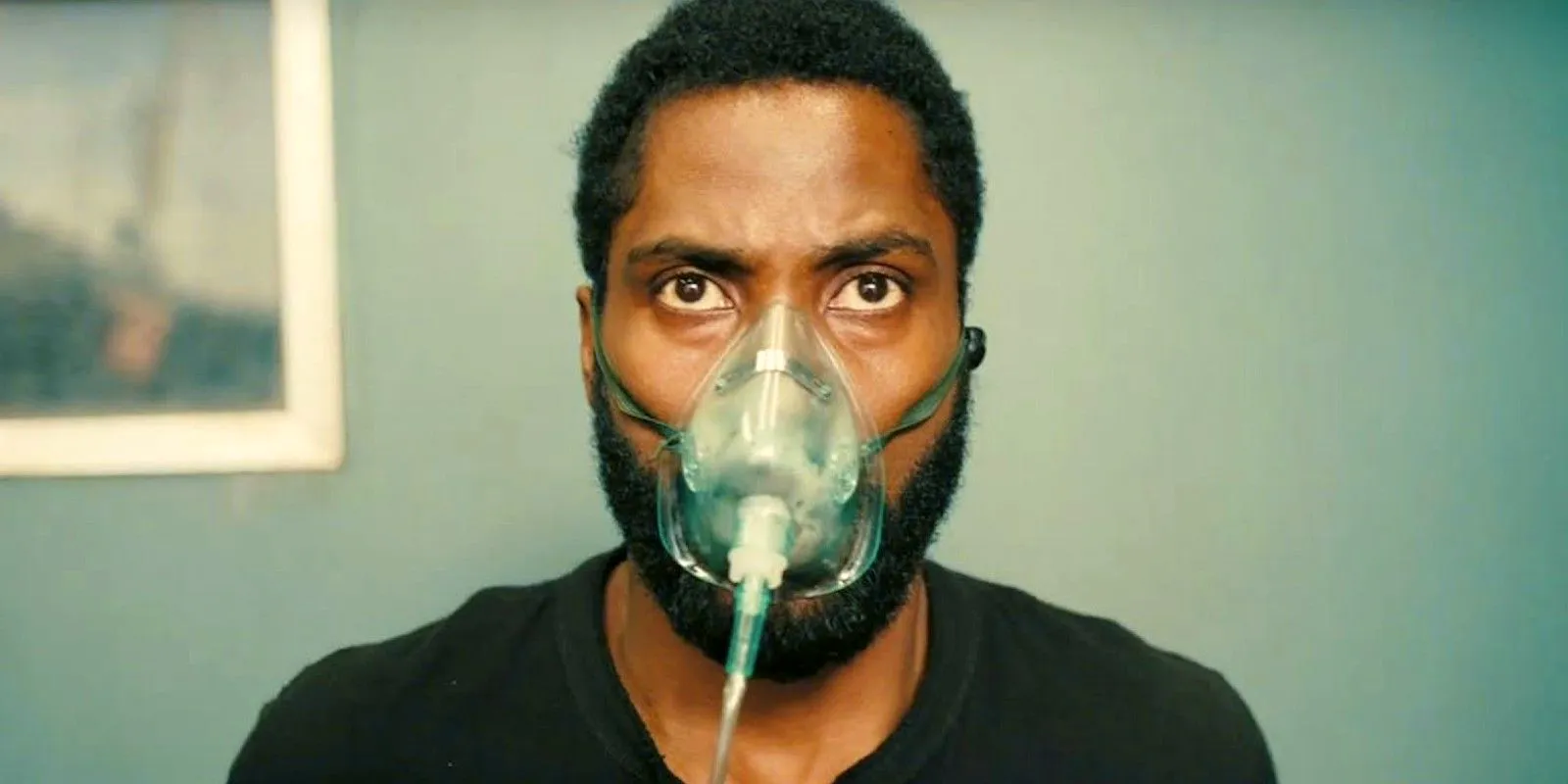 The Protagonist wears an oxygen mask in Tenet Image