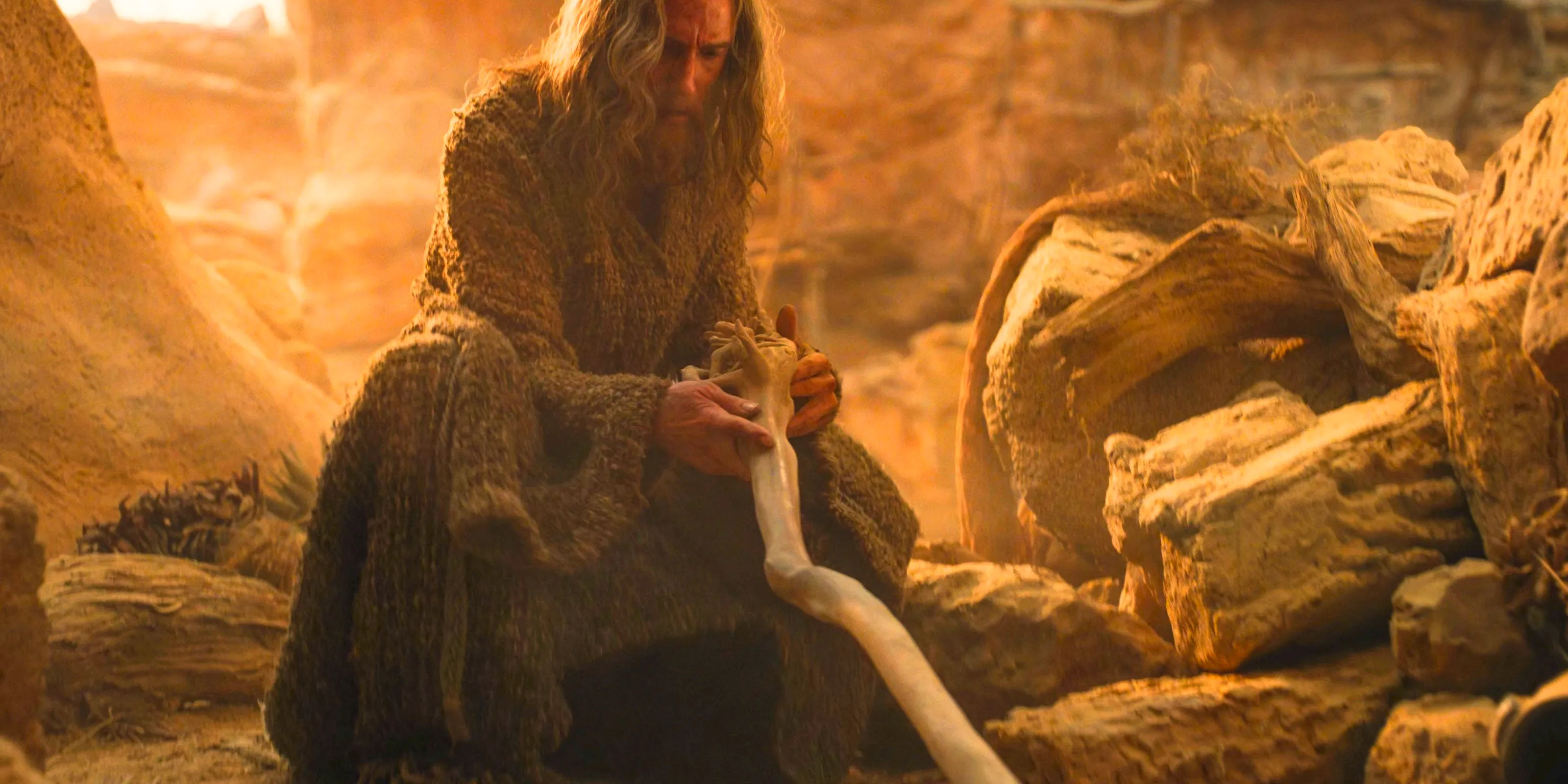 The Stranger (Daniel Weyman) finds his staff and acquires the name of Gandalf in The Lord of the Rings: The Rings of Power Season 2 Episode 8 Image