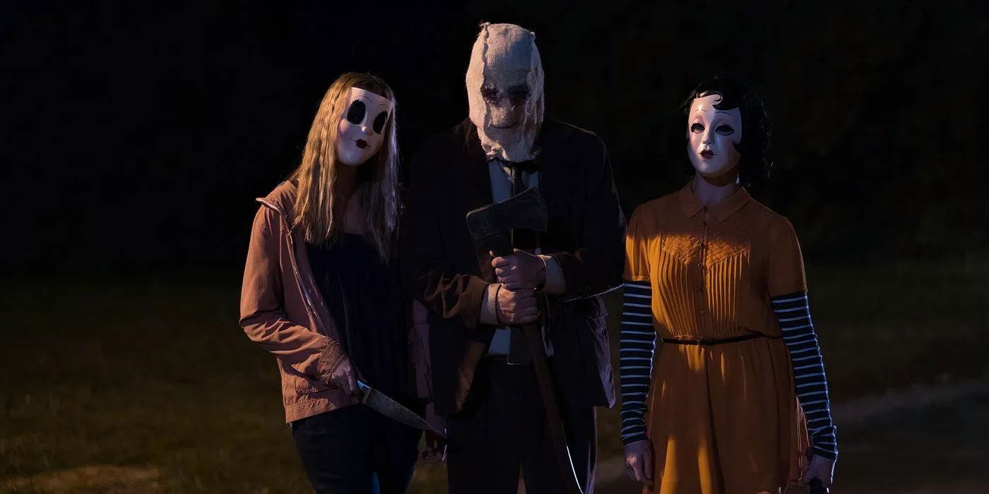 The three masked killers standing with weapons in The Strangers Prey at Night Image