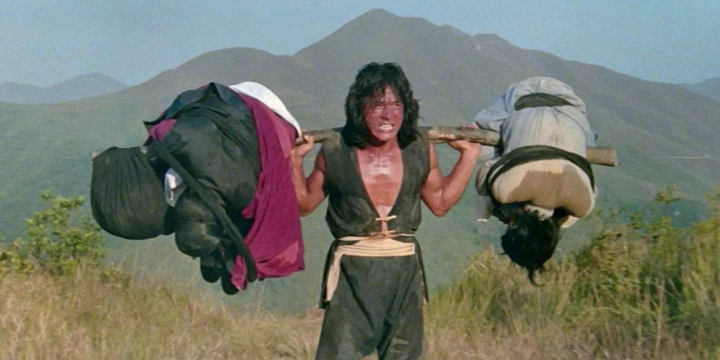 The Young Master Jackie Chan training with weights on his shoulders  Image