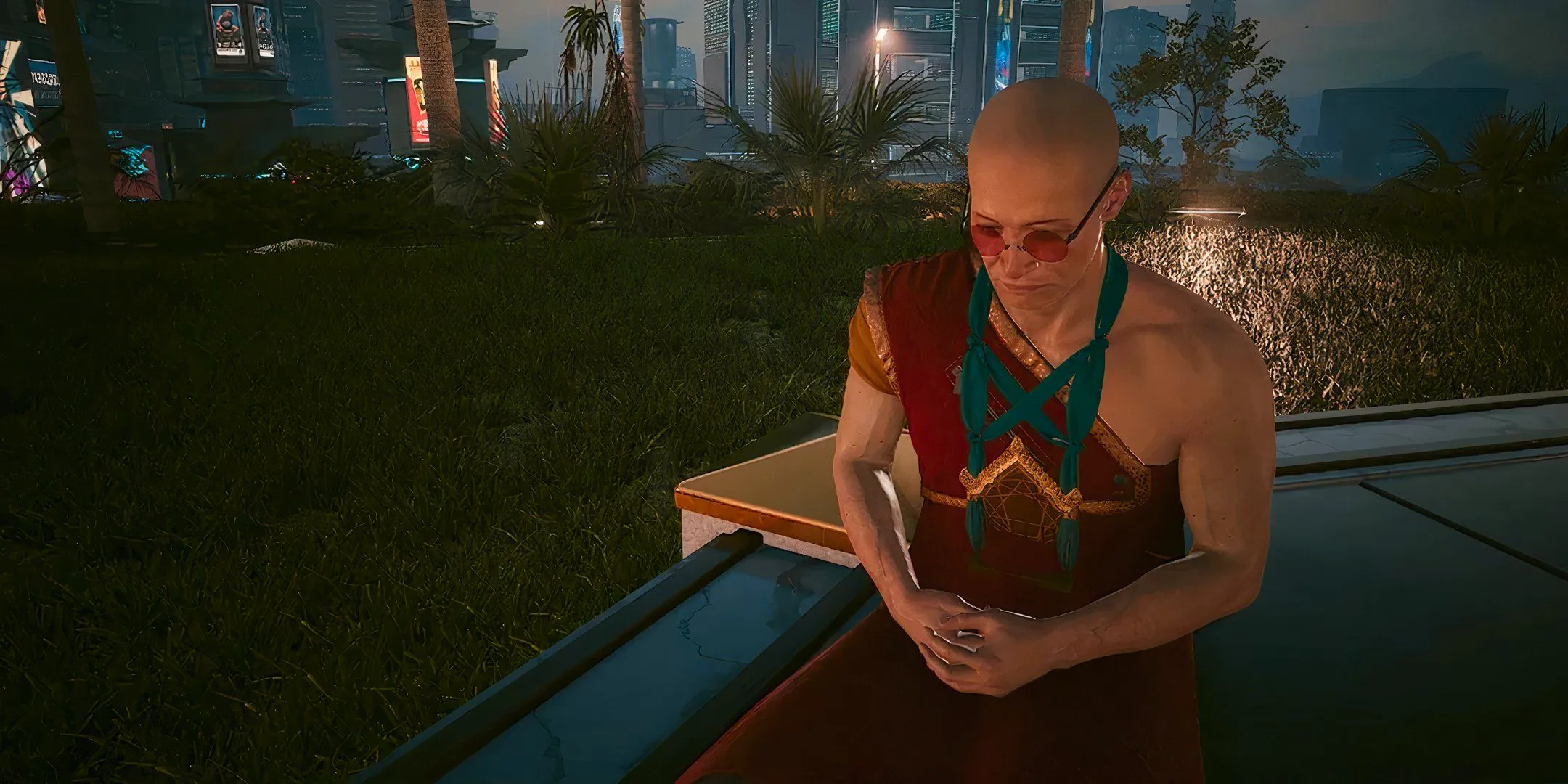 The Zen Master in Cyberpunk 2077 kneeling down with his hands clasped at night time with Night City in the background. Image