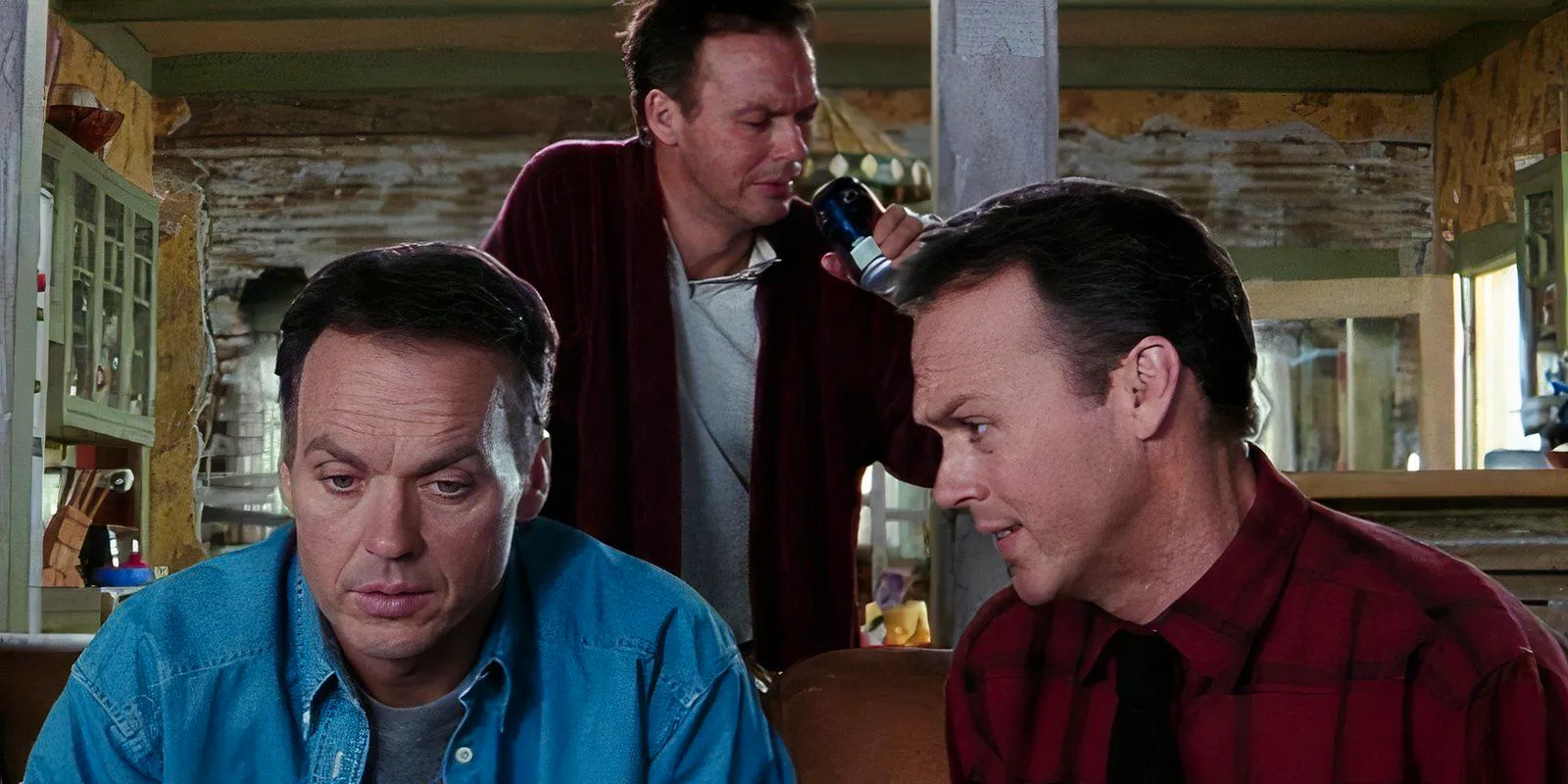 Three versions of Michael Keaton sitting around a couch in Multiplicity Image