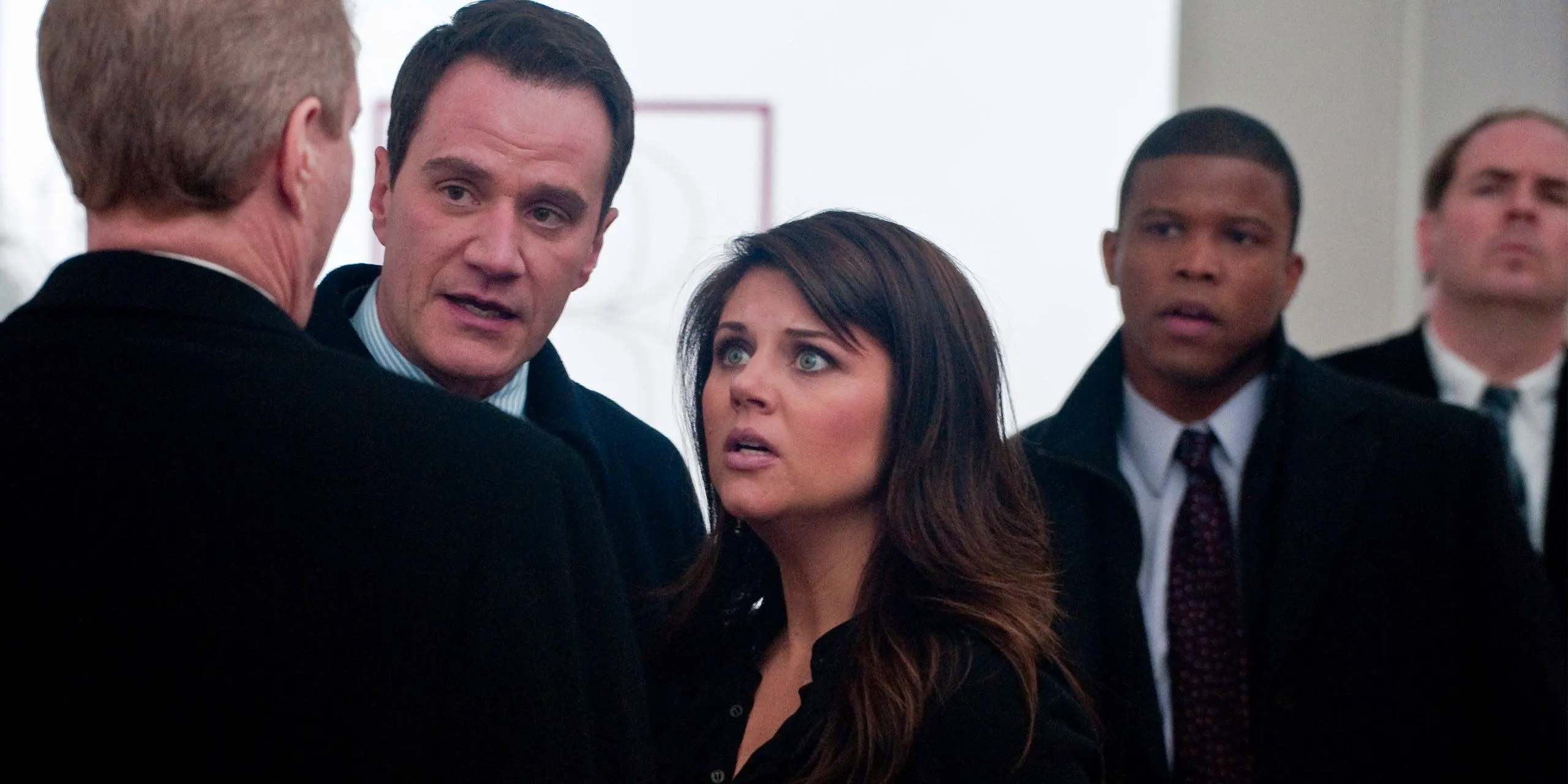 Tiffani Thiessen as Elizabeth Burke in White Collar looking worried with men in suits Image