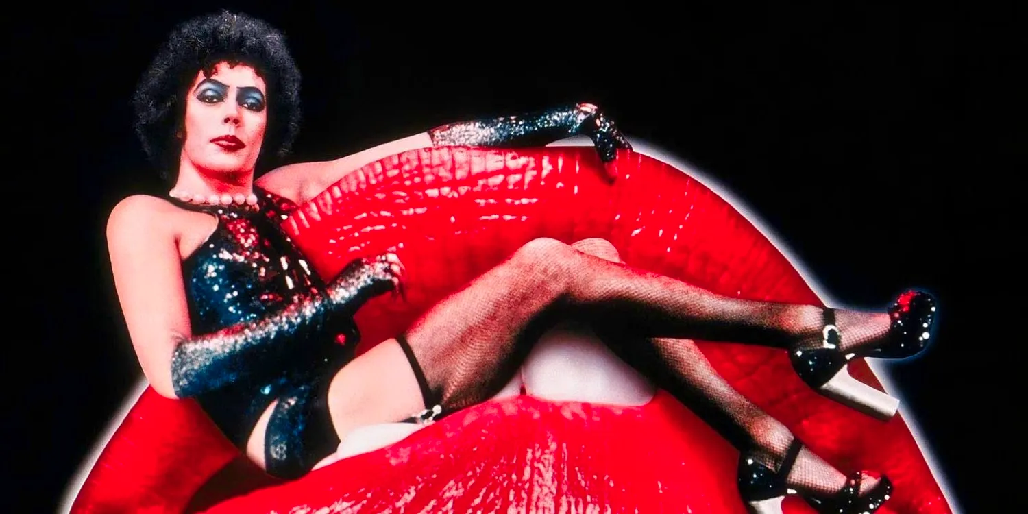 Tim Curry in full costume as Frank, sitting on the lips of the Rocky Horror Picture Show Image