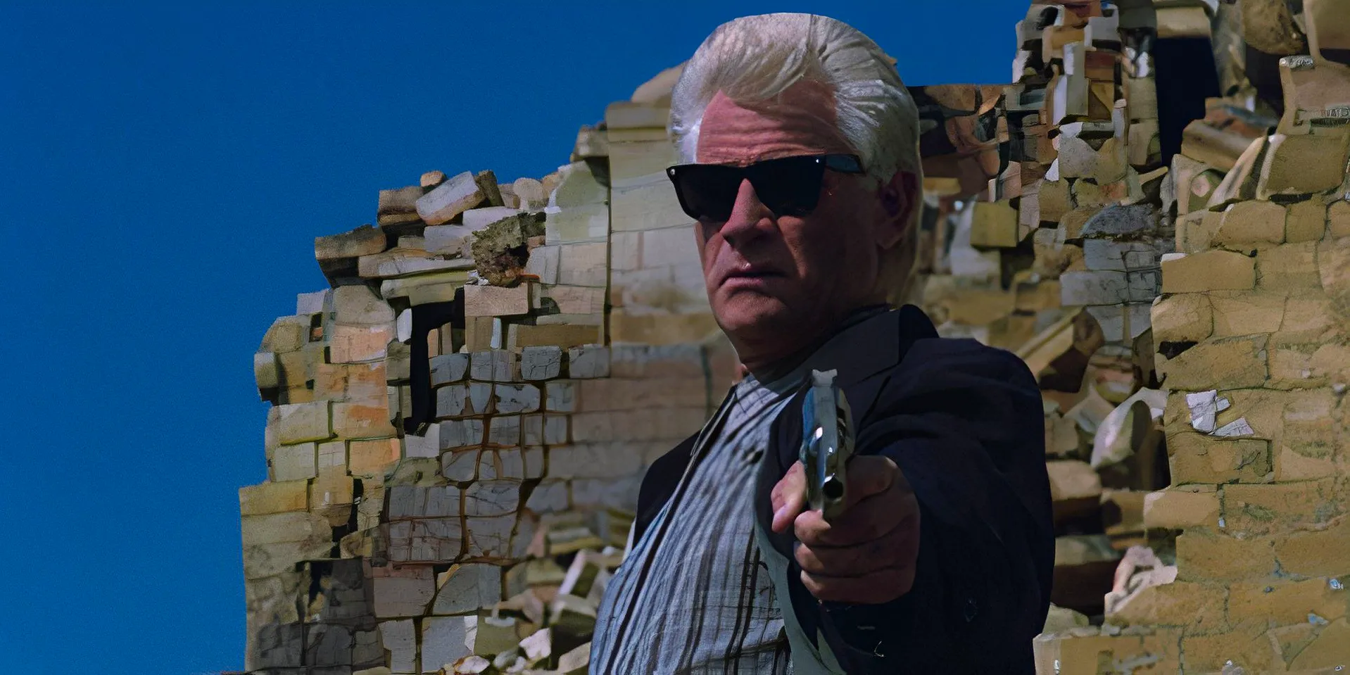 Tim Thomerson as Brick Bardo holding a gun in Dollman Image