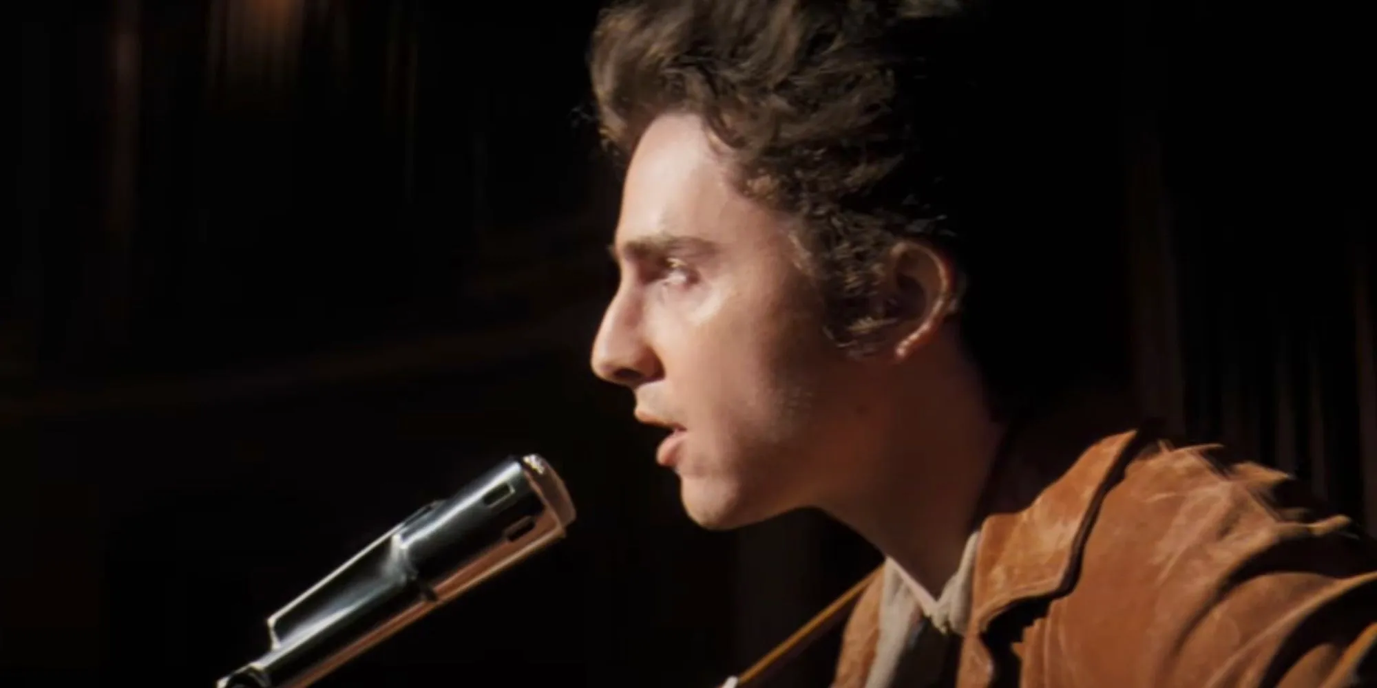 Timothee Chalamet as Bob Dylan singing in A Complete Unknown Image