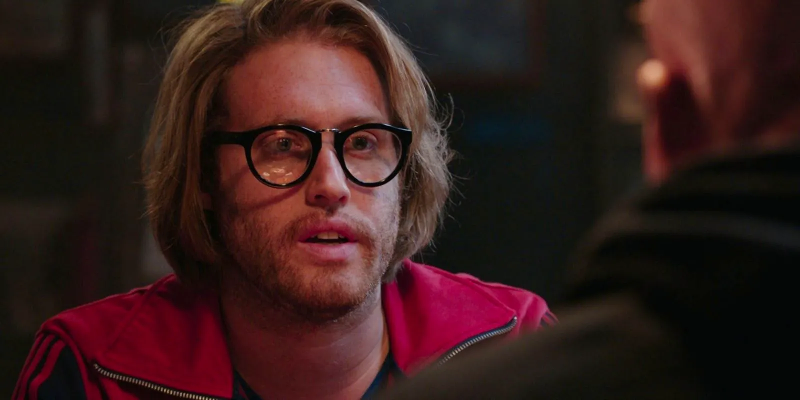 TJ Miller as Weasel speaking to Wade in a bar in Deadpool Image