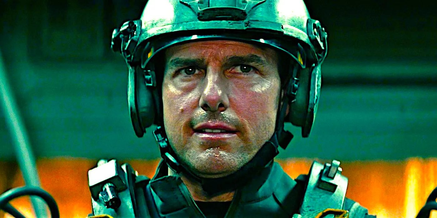 Tom Cruise perspiring while wearing heavy military gear in a scene from Edge of Tomorrow Image