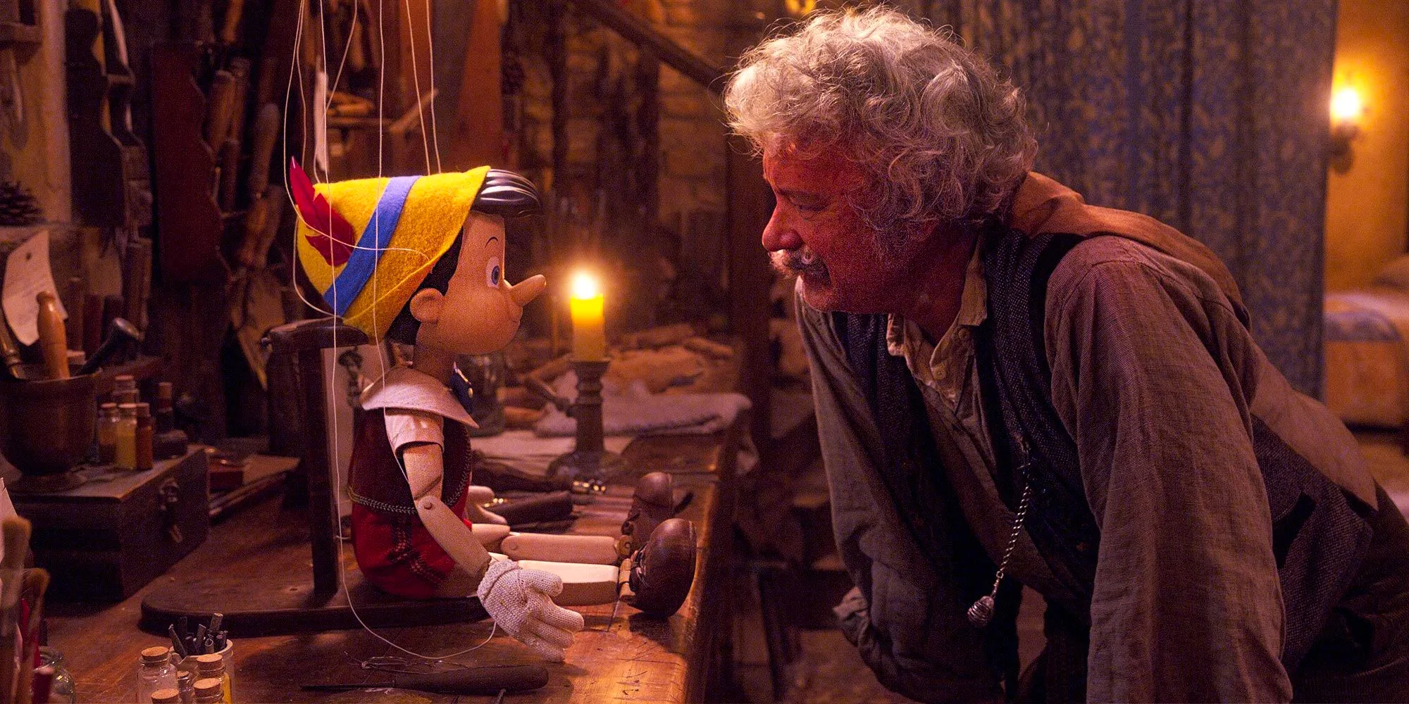 Tom Hanks as Geppetto talking to Pinocchio. Image