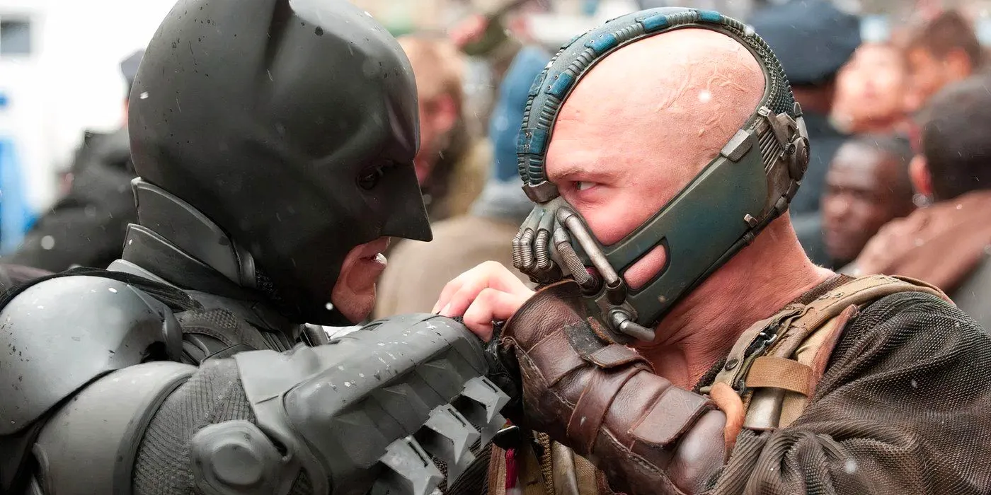 Tom Hardy as Bane grappling with Christian Bale as Batman in The Dark Knight Rises Image