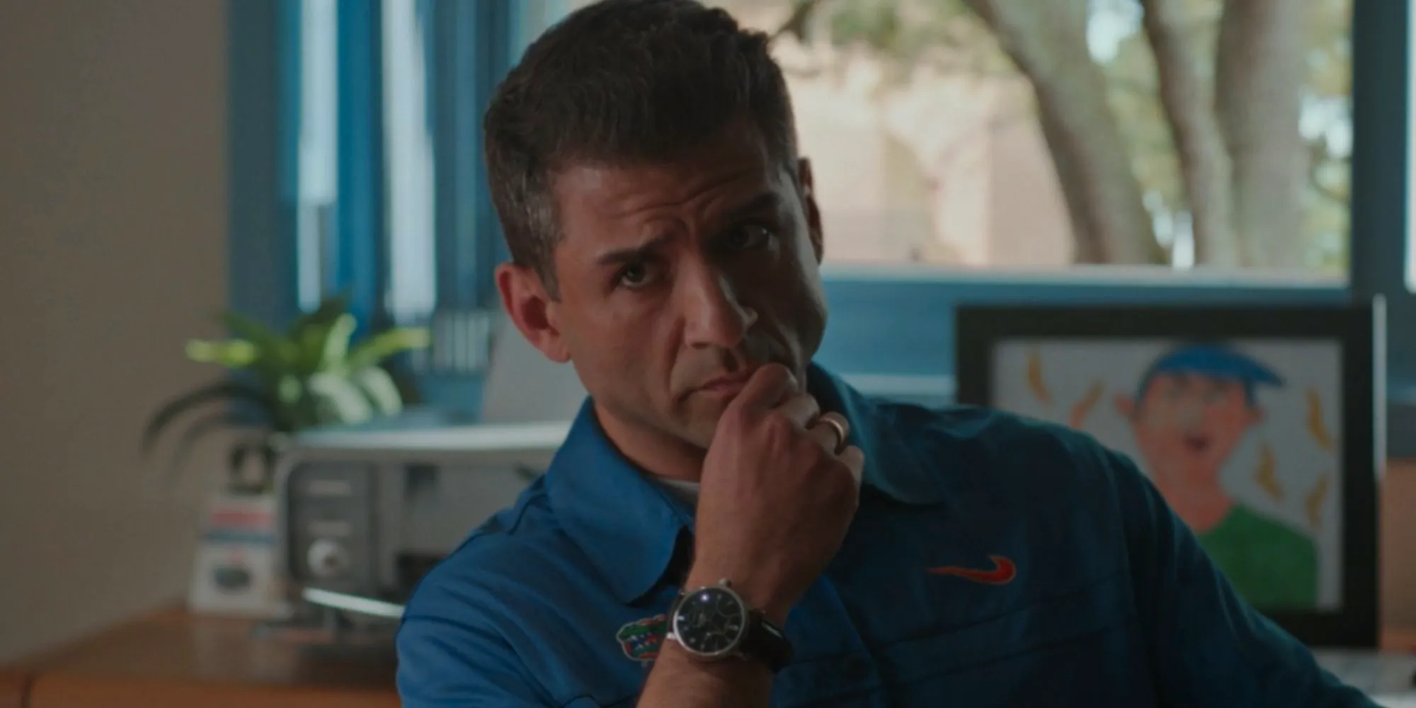 Tony Yazbeck as Urban Meyer looking thoughtful in American Sports Story Image