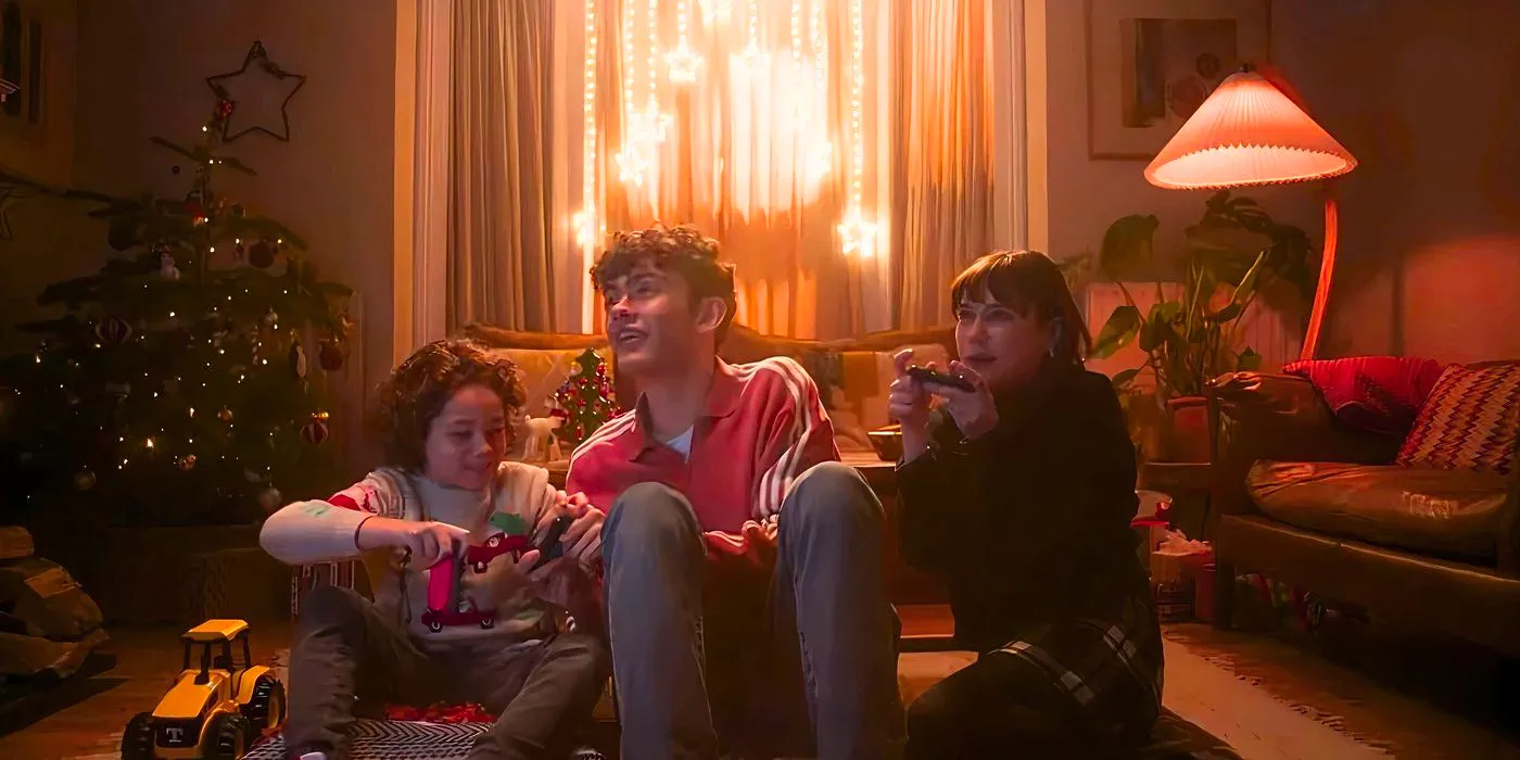 Tori (Jenny Walser), Charlie (Joe Locke) and Oliver play Mario Kart together on Christmas in Heartstopper season 3 Image