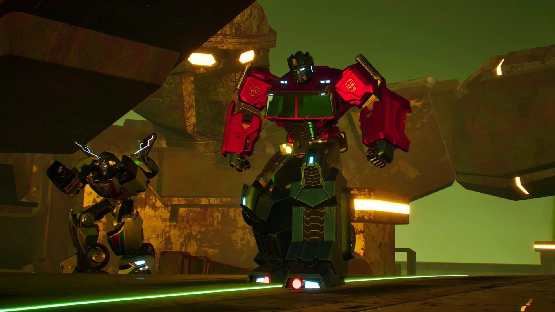 Transformers Galactic Trials Optimus Prime and Bumblebee standing next to one another, a stone Transformer structure is behind them. Image