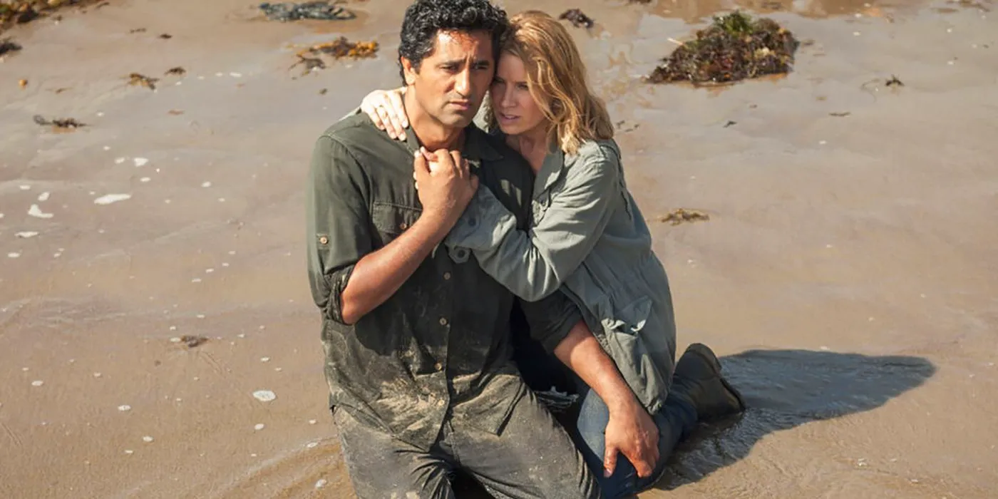 Travis, distraught on his knees, Madison consoling him on Fear the Walking Dead Image