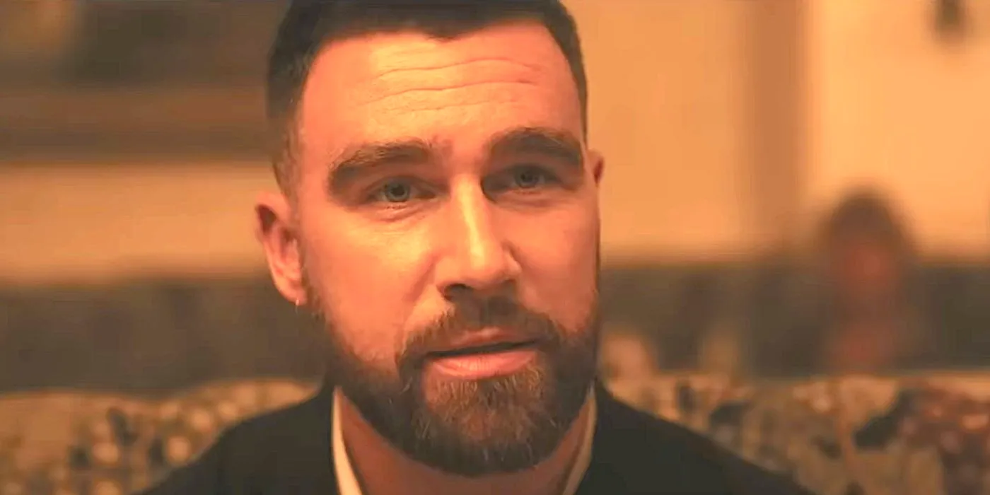 Travis Kelce's character looks serious in a restaurant from Grotesquerie's trailer Image