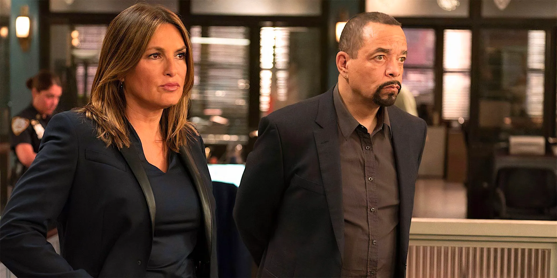 Two cast members from SVU standing side by side and looking at something off-screen Image