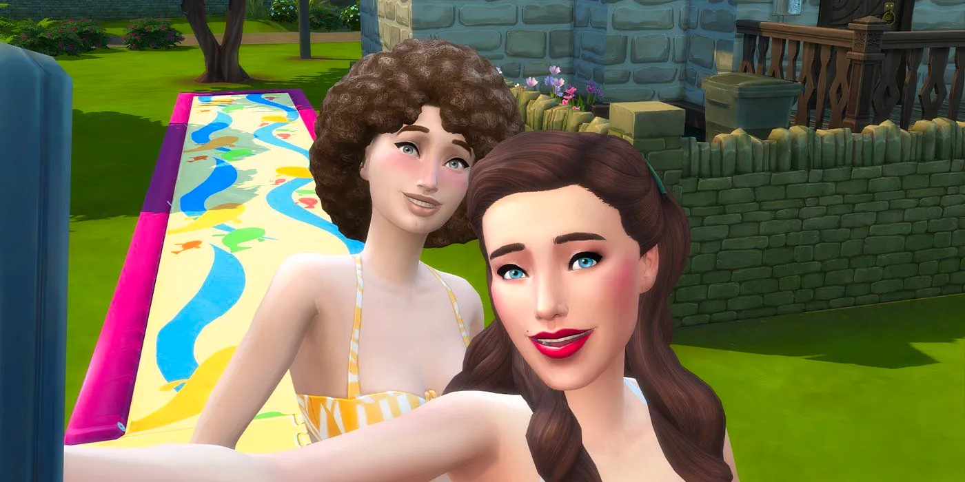 Two female sims in the Sims 4 wearing swimsuits by a colorful slip-n-slide. Image