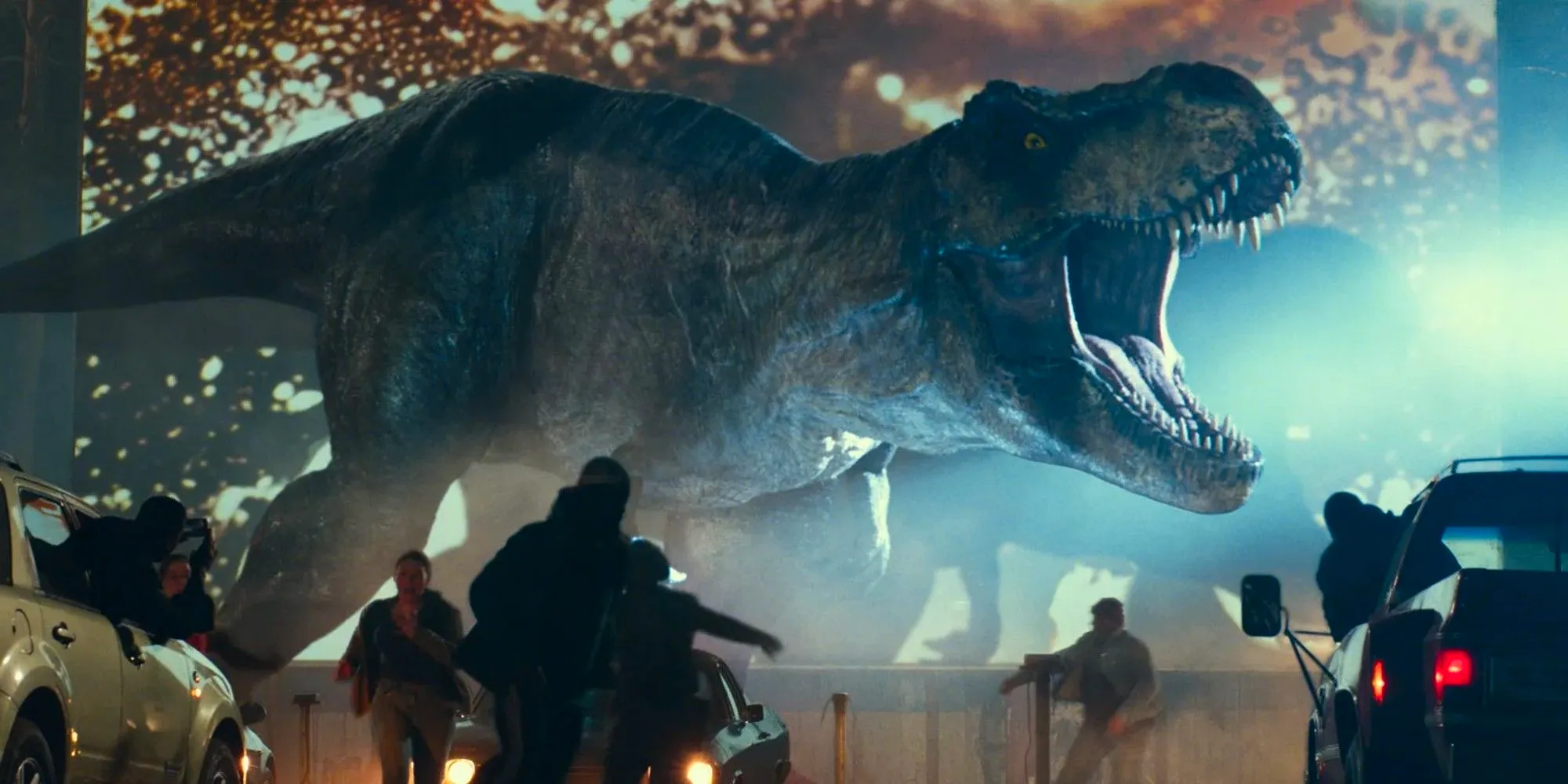 Tyranasaurus Rex reaping havoc at a drive in theater in Jurassic World Dominion Image