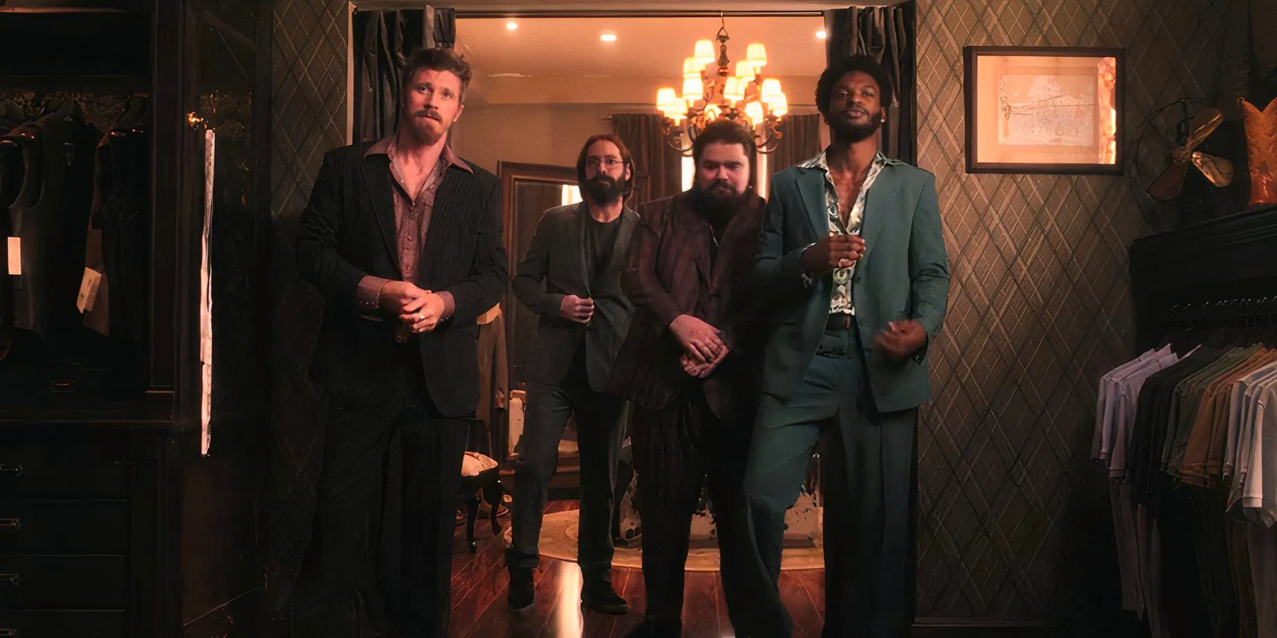 Tyson Mitchell (Jay Will), Fred (Justin Garcia-Pruneda), Bodhi (Martin Starr), and Mitch Keller (Garrett Hedlund) wearing suits in Tulsa King season 2, episode 1 Image