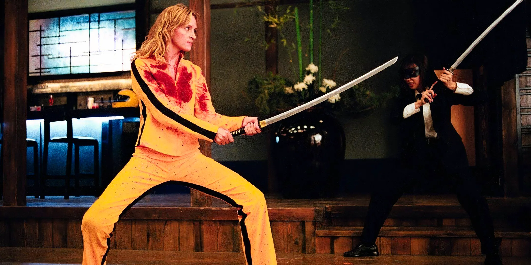 uma thurman wears a bloodied yellow tracksuit in the crazy 88 fight in kill bill: vol.1 Image