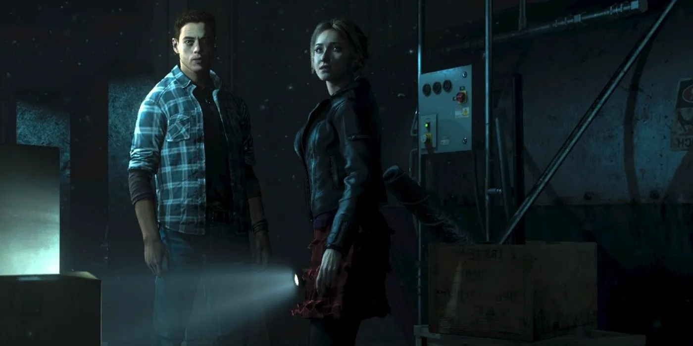 Until Dawn's Sam and Josh in a dark basement, looking behind them. Image