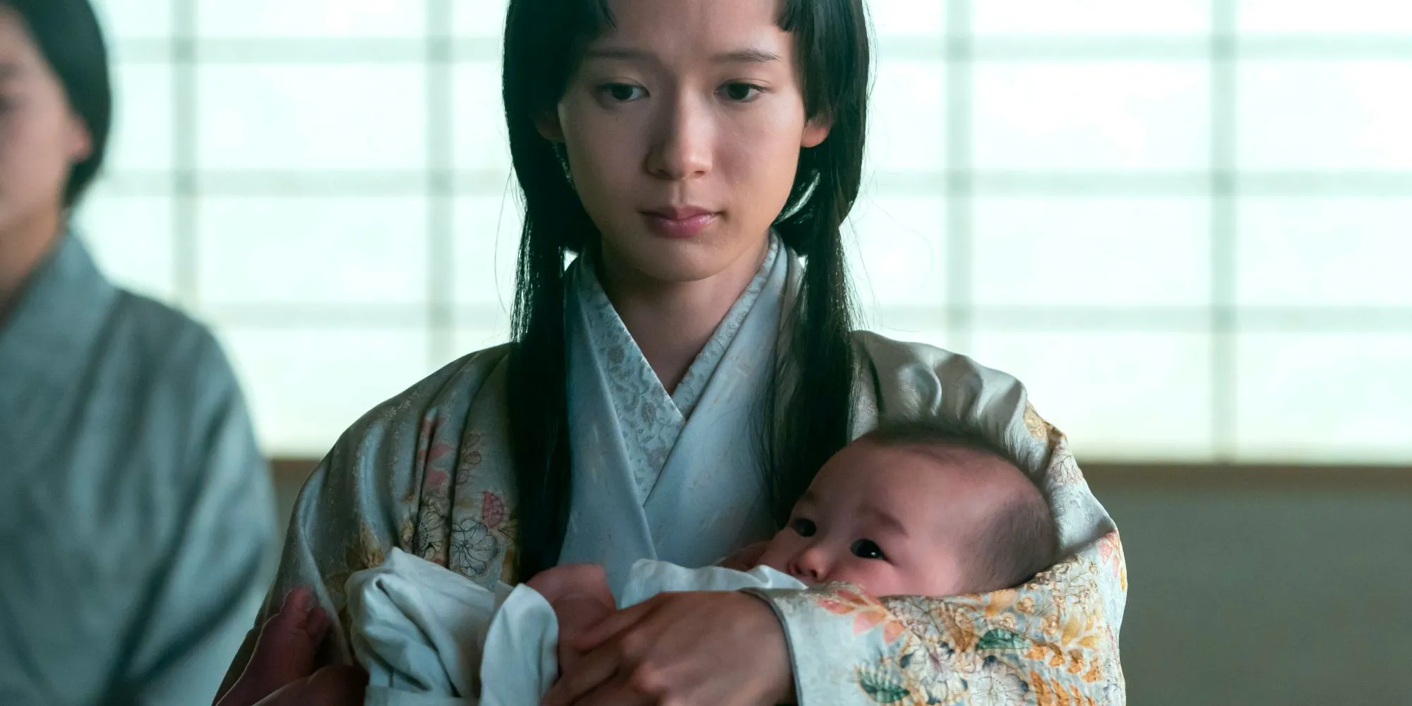 Usami Fuji holding her baby in her arms in Shogun episode 1 Image