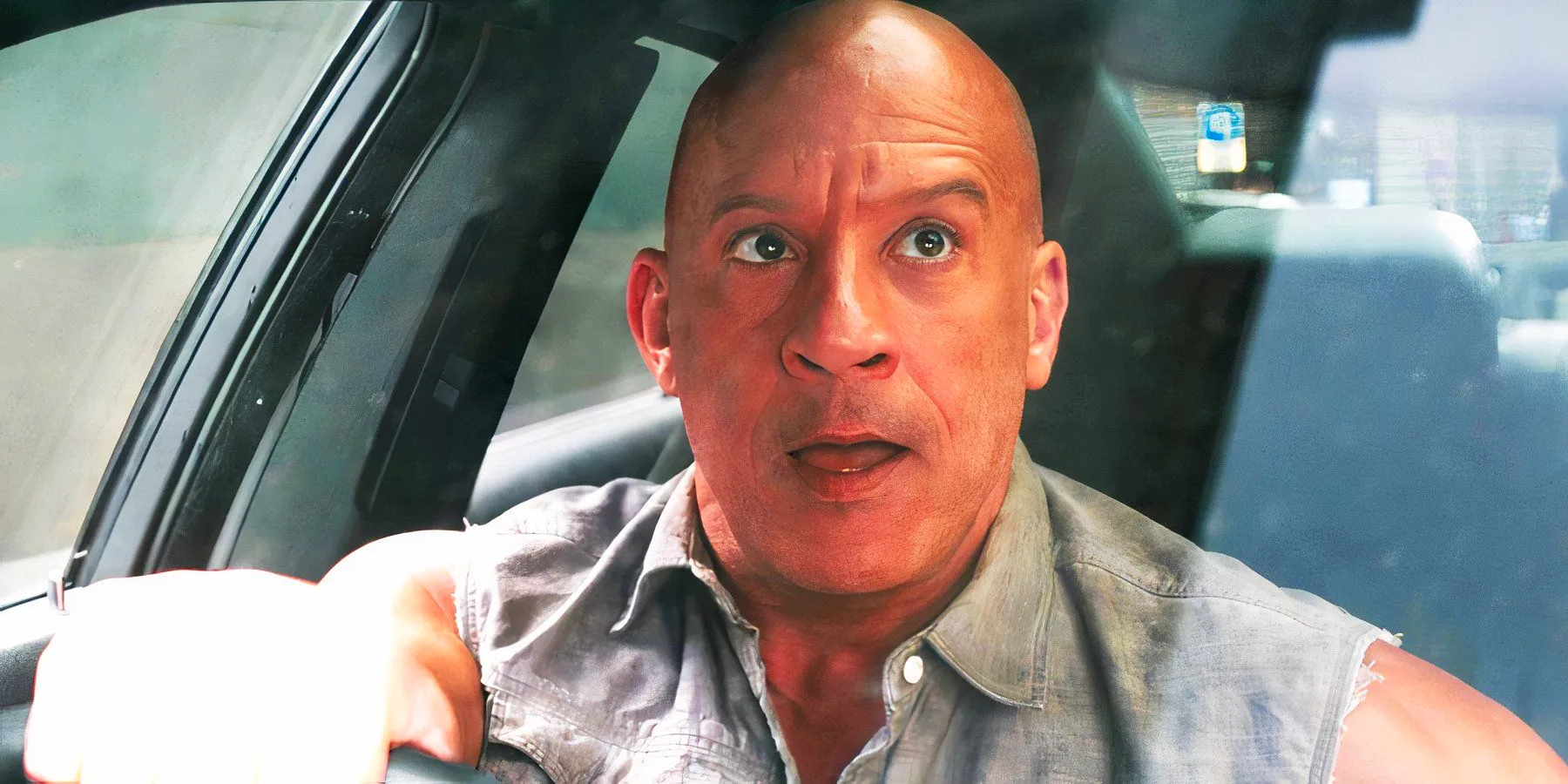 Vin Diesel as Dom Toretto looking in the rearview mirror in Fast X Image