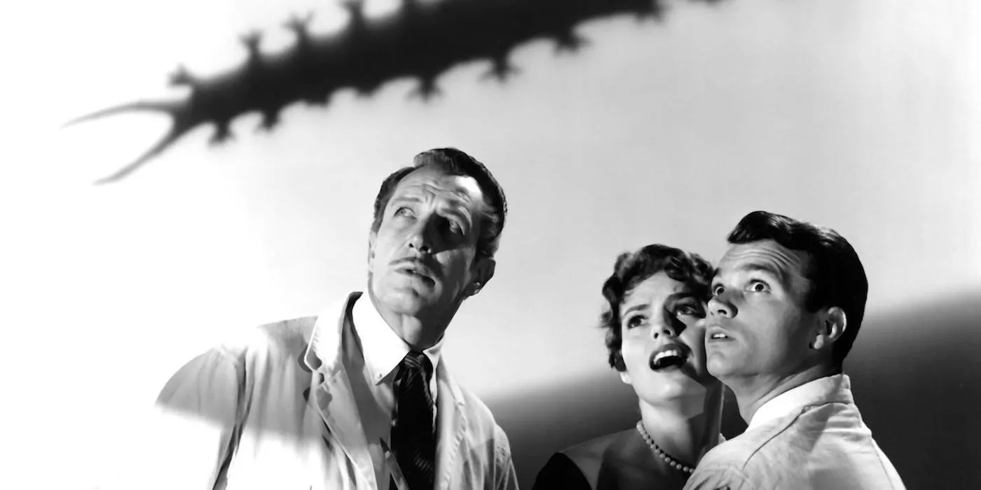 Vincent Price stars in The Tingler, shadow of the tingler above three scientists heads  Image