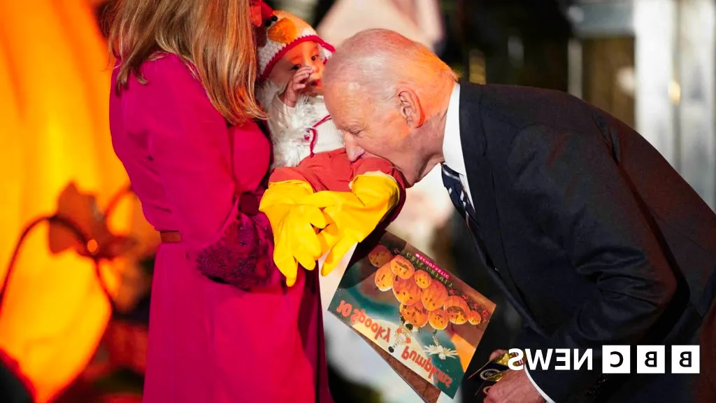 Watch: Biden playfully bites baby during White House trick or treat event Image