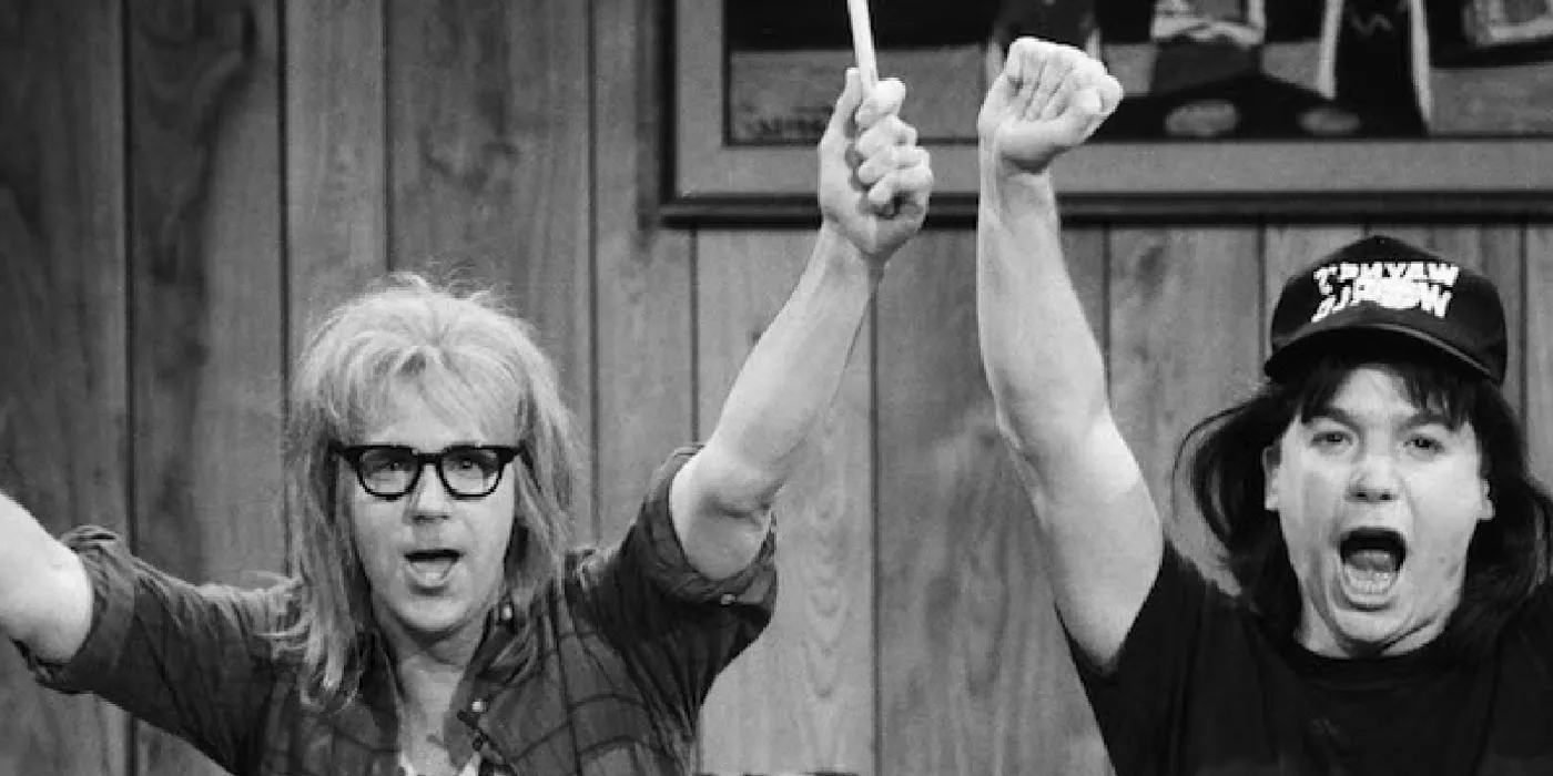 Wayne and Garth raise their arms in the air from the Wayne's World sketch on SNL Image