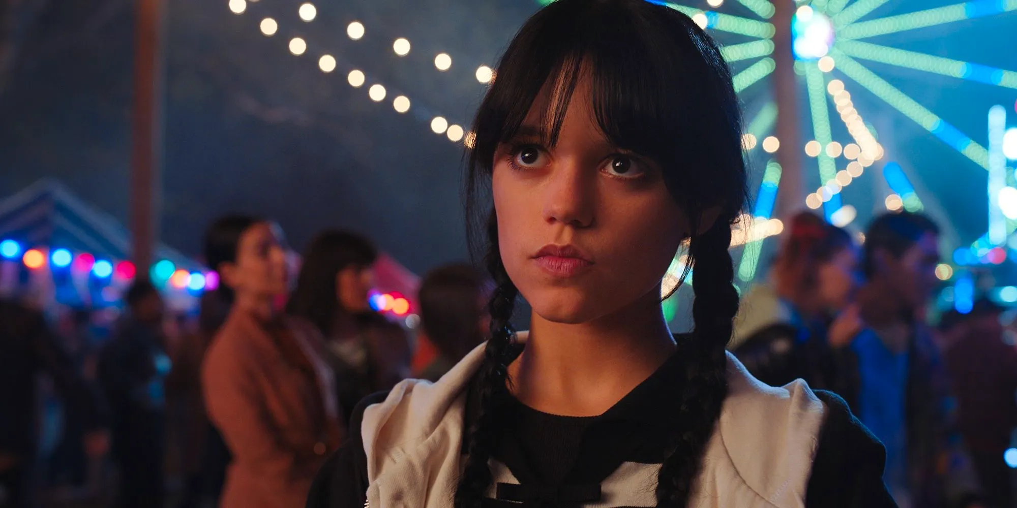 Wednesday (Jenna Ortega) stares ahead at the Harvest Festival in Wednesday Image