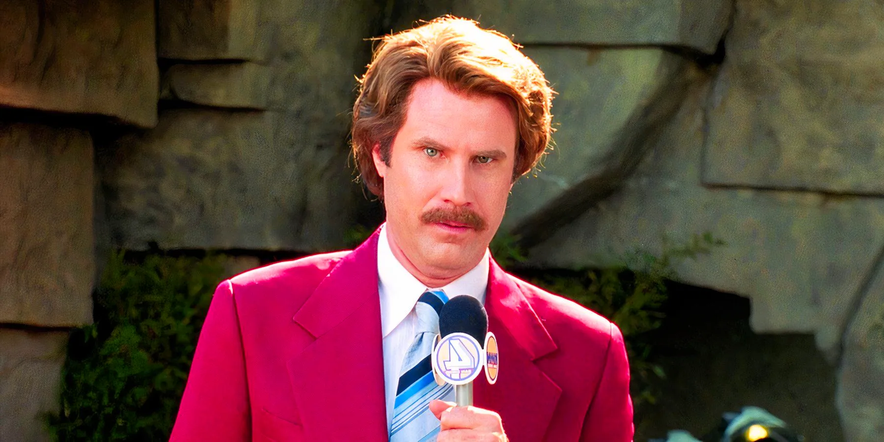 Will Ferrell holding a mic as Ron Burgundy in Anchorman Image